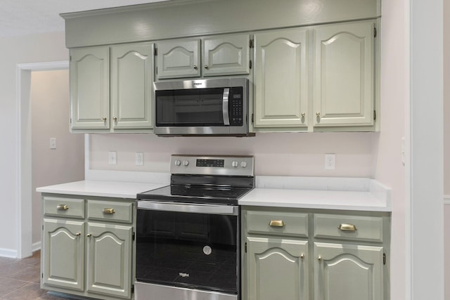 kitchen with tile patterned flooring and stainless steel appliances