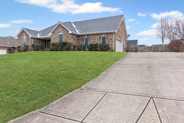 ranch-style home featuring a front yard and a garage