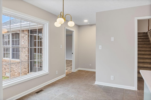 unfurnished dining area with a chandelier and tile patterned flooring