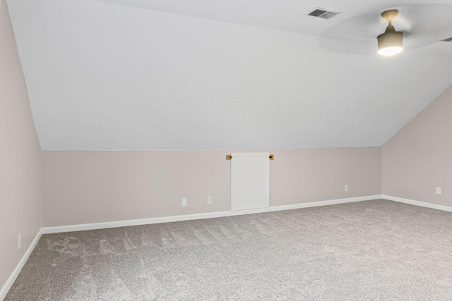 bonus room with lofted ceiling and carpet floors