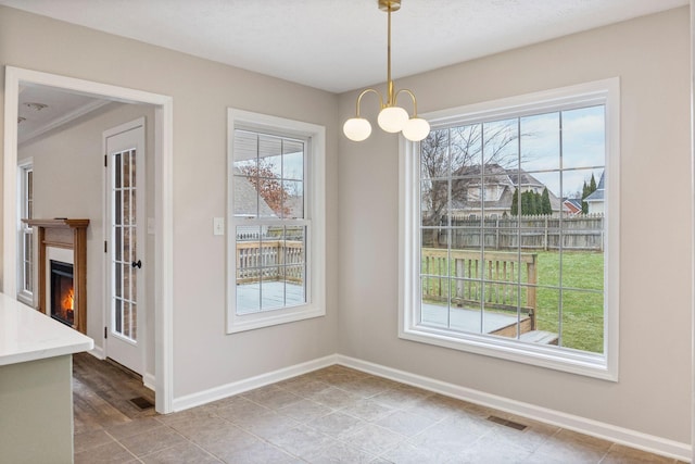 unfurnished dining area featuring a notable chandelier