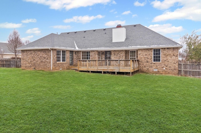 back of house with a deck and a yard