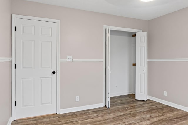 unfurnished bedroom featuring dark wood-type flooring