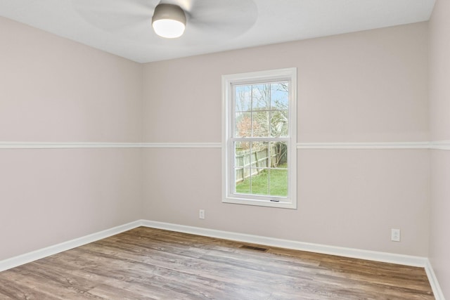 unfurnished room with wood-type flooring