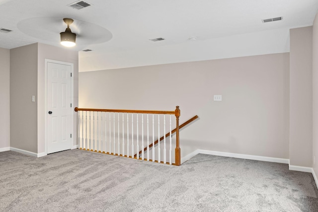 spare room featuring carpet flooring and ceiling fan