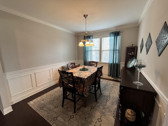 dining room with ornamental molding, dark wood-type flooring, and a notable chandelier