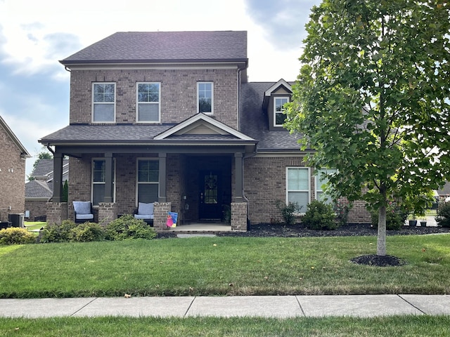 view of front of house featuring cooling unit and a front yard