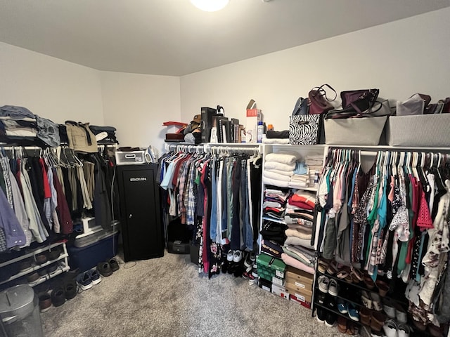 walk in closet with carpet