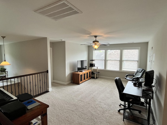 carpeted home office with ceiling fan