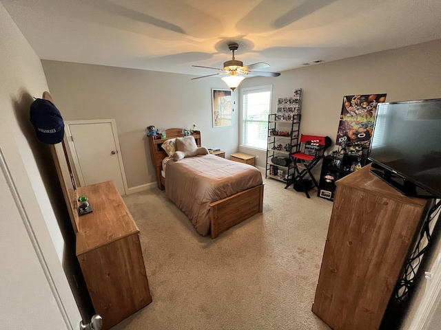 bedroom with light carpet and ceiling fan