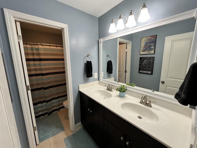 bathroom featuring tile patterned flooring, vanity, and toilet