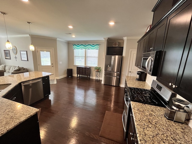 kitchen featuring appliances with stainless steel finishes, light stone counters, ornamental molding, decorative light fixtures, and dark hardwood / wood-style floors