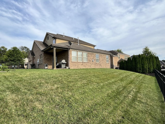 rear view of property featuring a yard