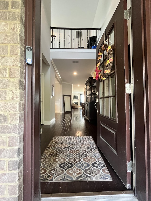 entrance foyer featuring dark hardwood / wood-style floors and crown molding