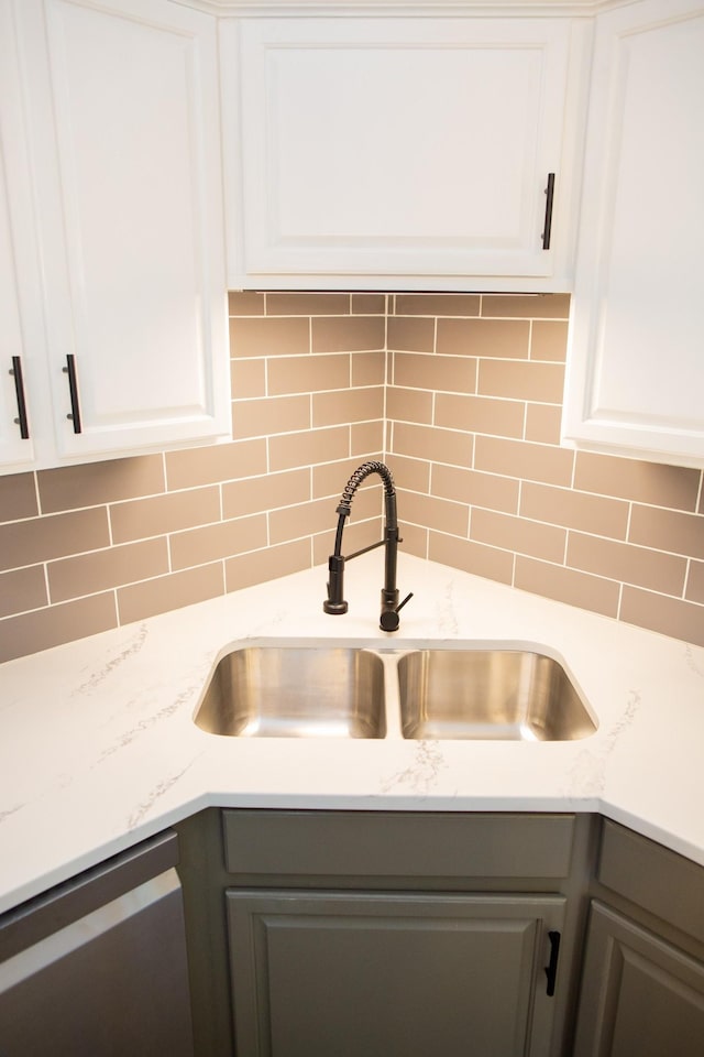 details featuring white cabinetry, sink, gray cabinetry, and dishwasher