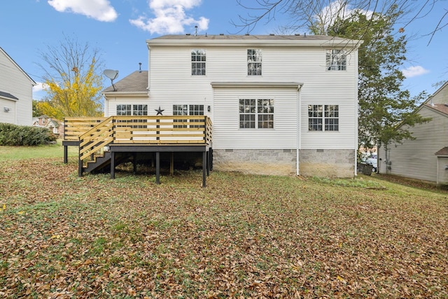 rear view of house featuring a yard and a deck