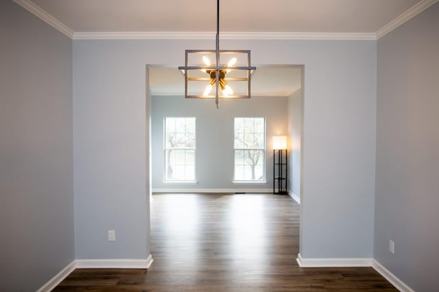 unfurnished dining area featuring ornamental molding, a chandelier, and dark hardwood / wood-style flooring