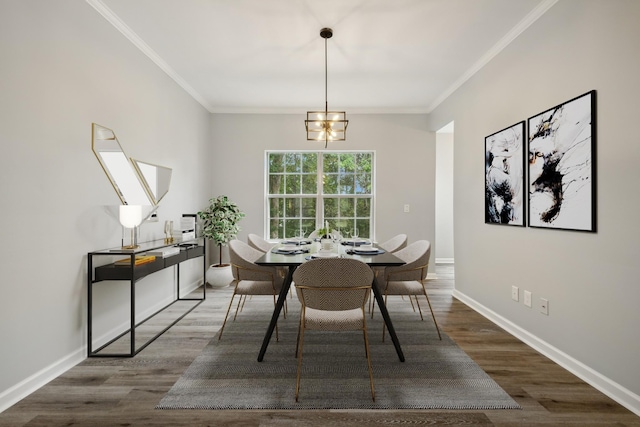 dining space featuring ornamental molding, dark wood-type flooring, and an inviting chandelier