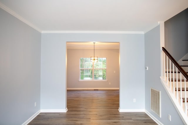 spare room with dark hardwood / wood-style flooring and ornamental molding