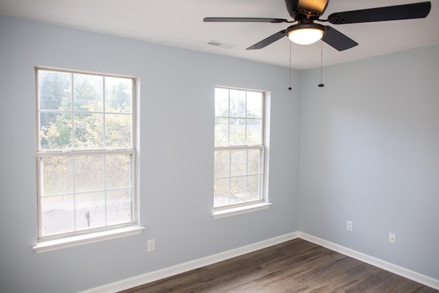 unfurnished room with dark hardwood / wood-style flooring and ceiling fan