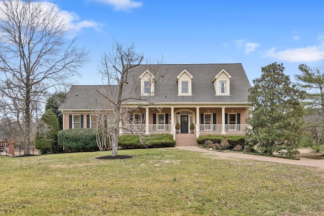 cape cod home featuring a front yard and a porch