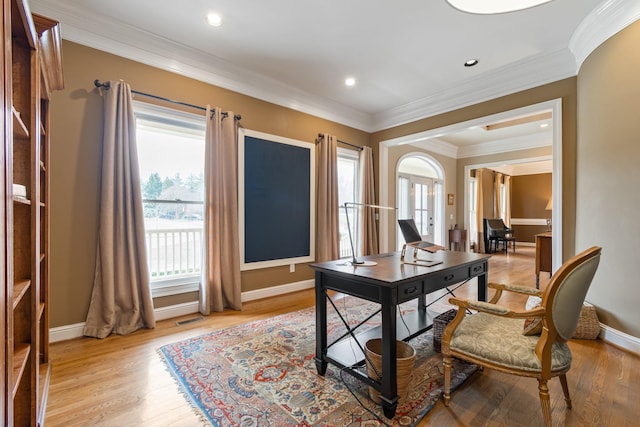 office area featuring crown molding and light hardwood / wood-style flooring