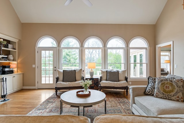 living room with vaulted ceiling, ceiling fan, and light hardwood / wood-style floors