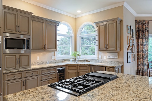 kitchen featuring crown molding, stainless steel microwave, wine cooler, light stone countertops, and black gas stovetop