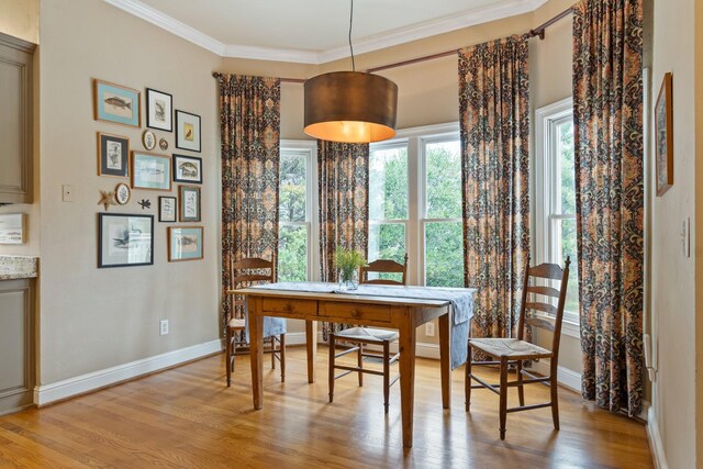 dining area featuring light hardwood / wood-style flooring and ornamental molding