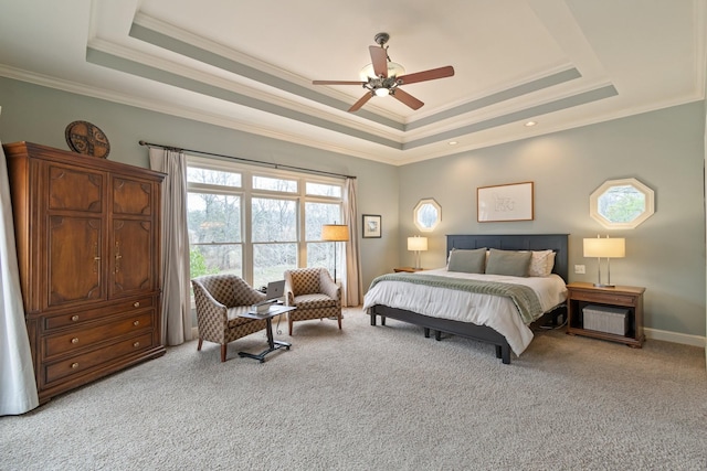 carpeted bedroom featuring crown molding, ceiling fan, and a raised ceiling