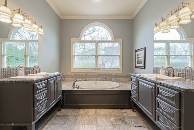 bathroom featuring ornamental molding, a bath, and vanity