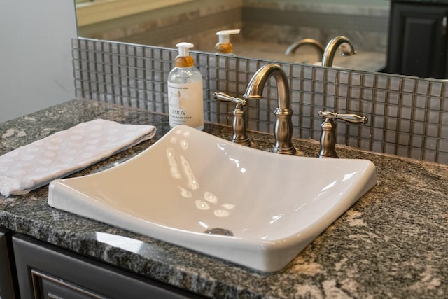 details featuring tasteful backsplash and sink