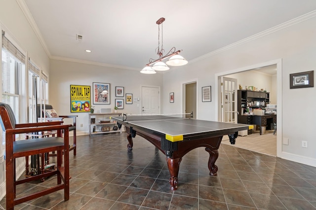 recreation room with dark tile patterned floors and ornamental molding