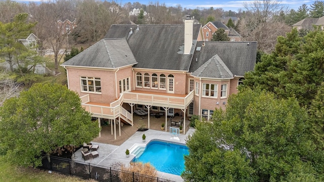 back of house featuring a pool side deck and a patio area