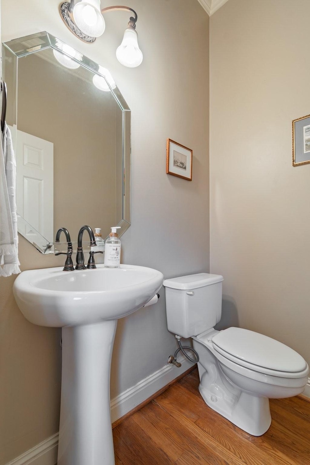 bathroom featuring hardwood / wood-style floors, sink, and toilet