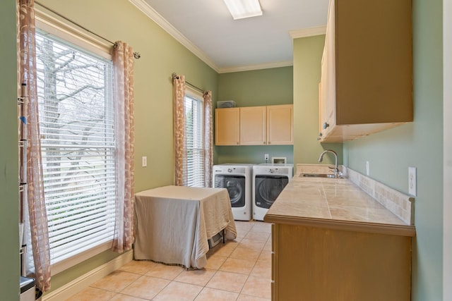 laundry room featuring sink, washer and clothes dryer, cabinets, ornamental molding, and light tile patterned flooring