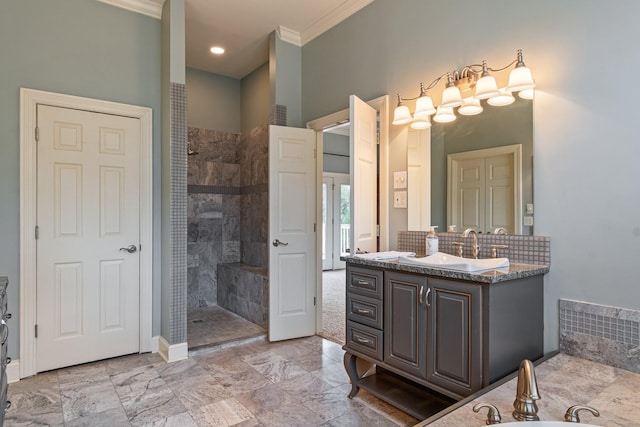 bathroom featuring ornamental molding, vanity, decorative backsplash, and a tile shower