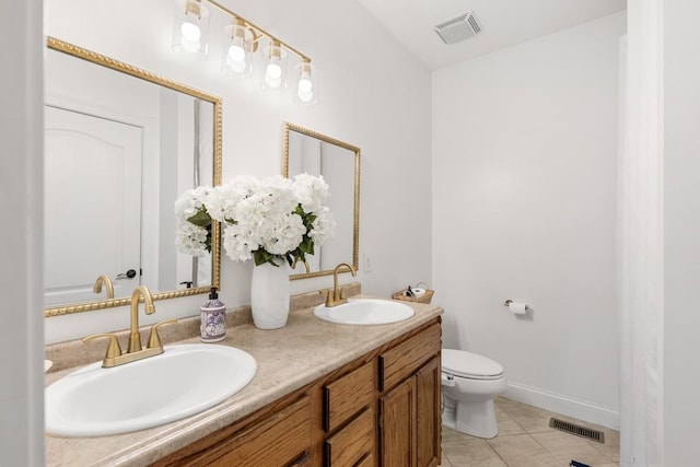 bathroom featuring toilet, vanity, and tile patterned floors