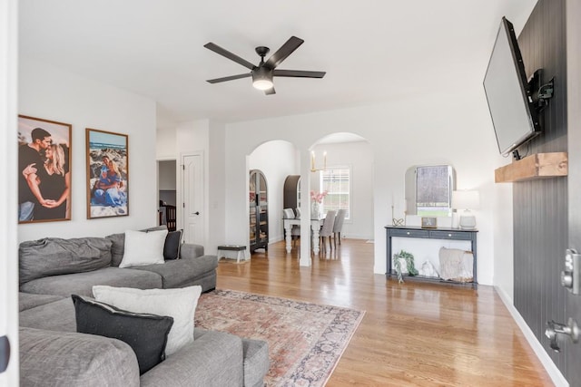 living room featuring light wood-type flooring and ceiling fan