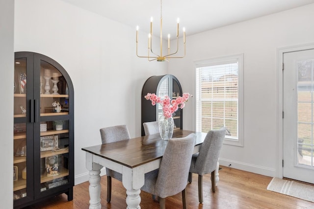 dining room featuring light hardwood / wood-style floors and an inviting chandelier