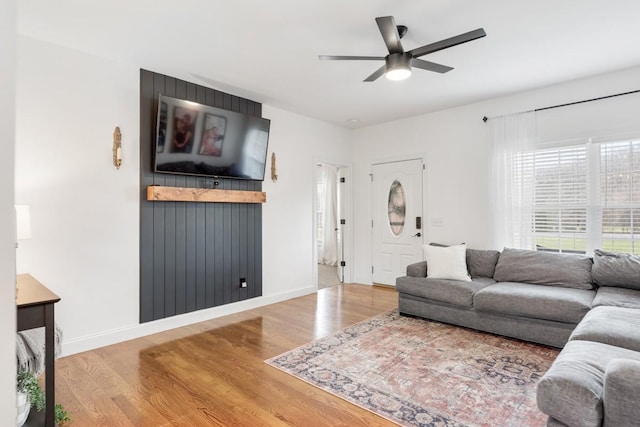 living room featuring hardwood / wood-style flooring and ceiling fan