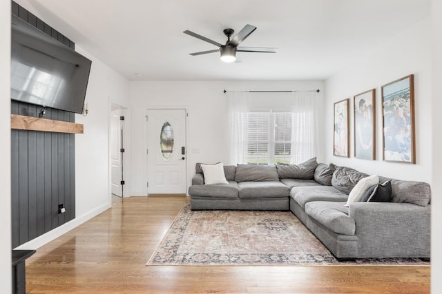 living room with hardwood / wood-style floors and ceiling fan