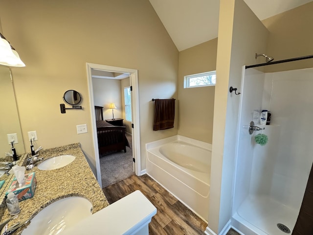 bathroom with shower with separate bathtub, vanity, lofted ceiling, and hardwood / wood-style flooring