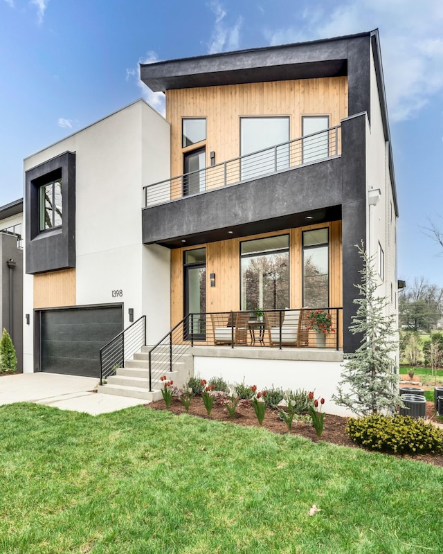 modern home with central AC unit, a balcony, a garage, and a front lawn