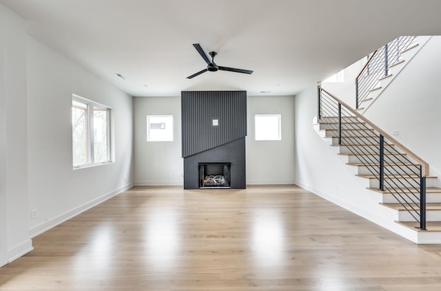 unfurnished living room featuring light hardwood / wood-style floors and ceiling fan