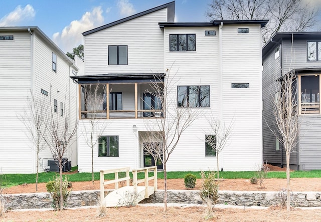 back of house featuring a balcony and central air condition unit