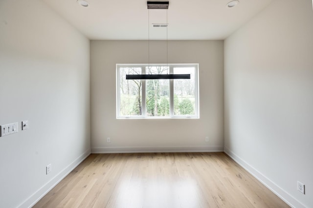 spare room with light hardwood / wood-style floors