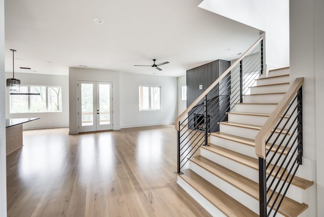 entryway with ceiling fan, wood-type flooring, and french doors