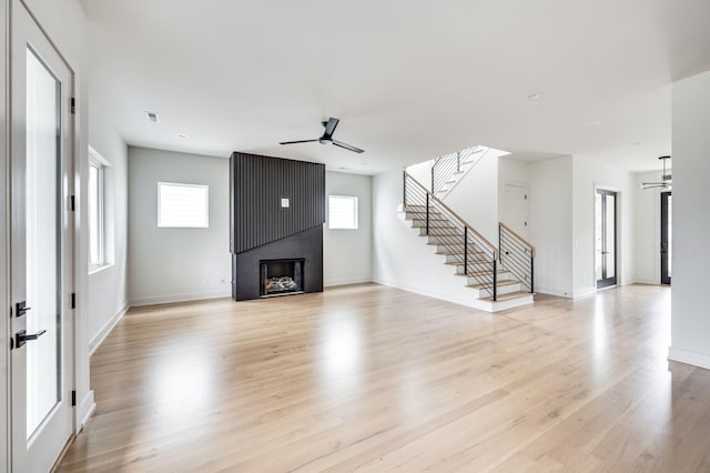 unfurnished living room featuring light wood-type flooring and ceiling fan