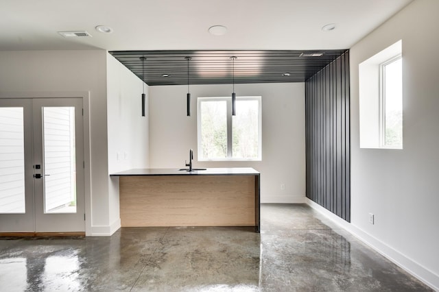 kitchen featuring french doors, concrete floors, a wealth of natural light, and sink